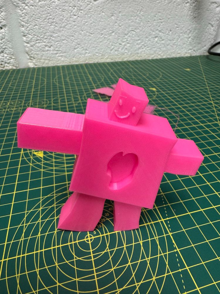 Pink 3D print of a robot based on a drawing by my daughter. 
