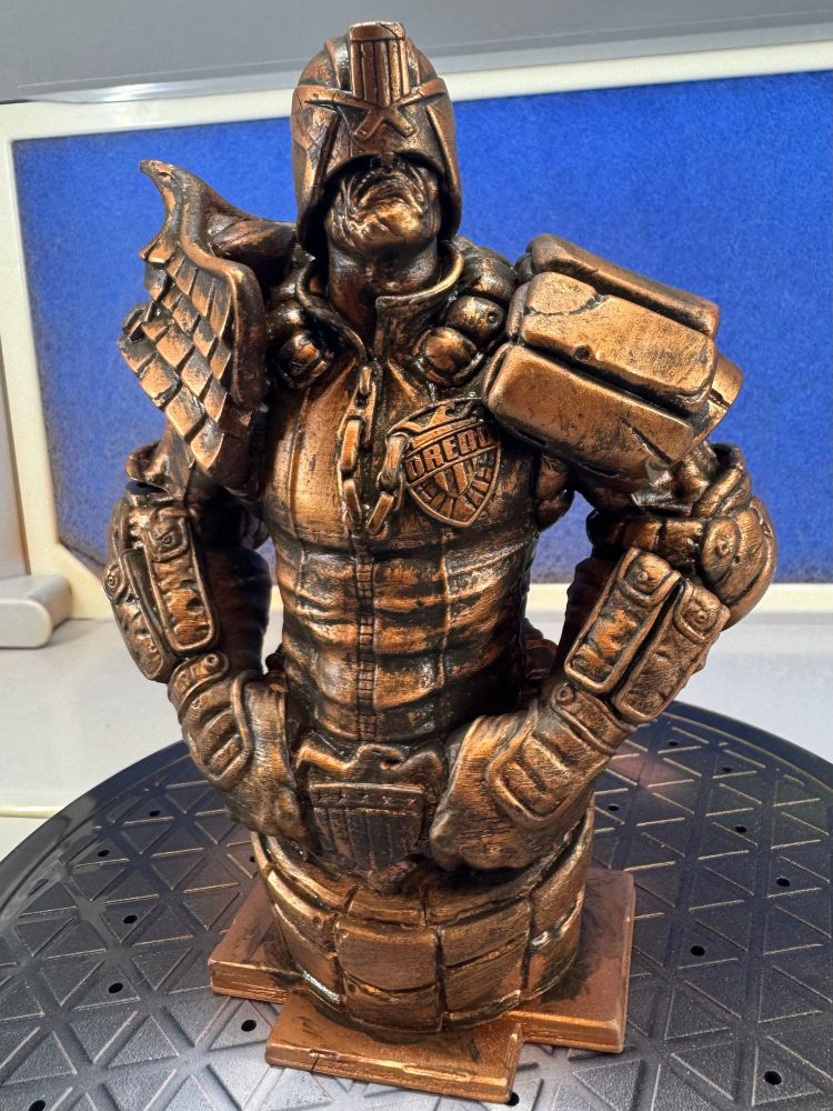 3D printed bust of Judge Dredd sprayed metallic copper and then weathered with acrylic paints. 