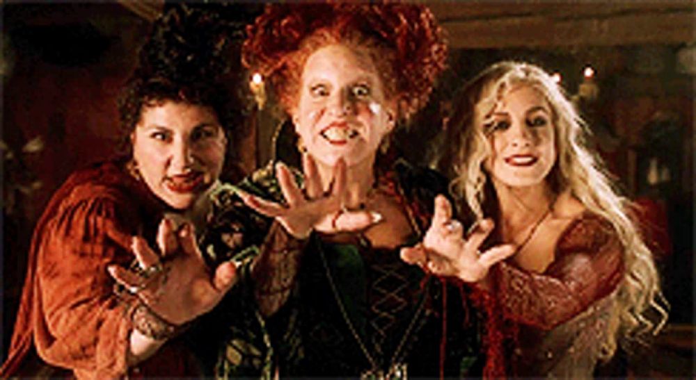 three witches are posing for a picture with their hands out