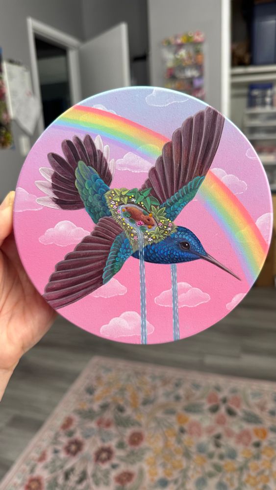 A capybara cools off in a small pool of water riding on the back of a blue and green hummingbird, zooming through a pink sky past a rainbow