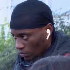 very serious person with headphones on, looking angry 