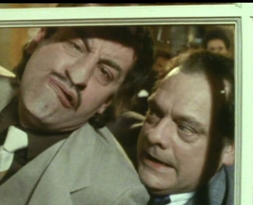 Man pressing another man's face up against window