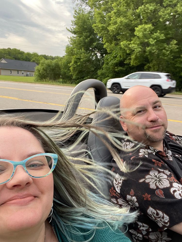 Prodigal Hoosier & Bellmore riding in the convertible she’s wearing a PAIR of glasses (from PAIR) with the Seascape (sailboat) painting by Van Gogh. 