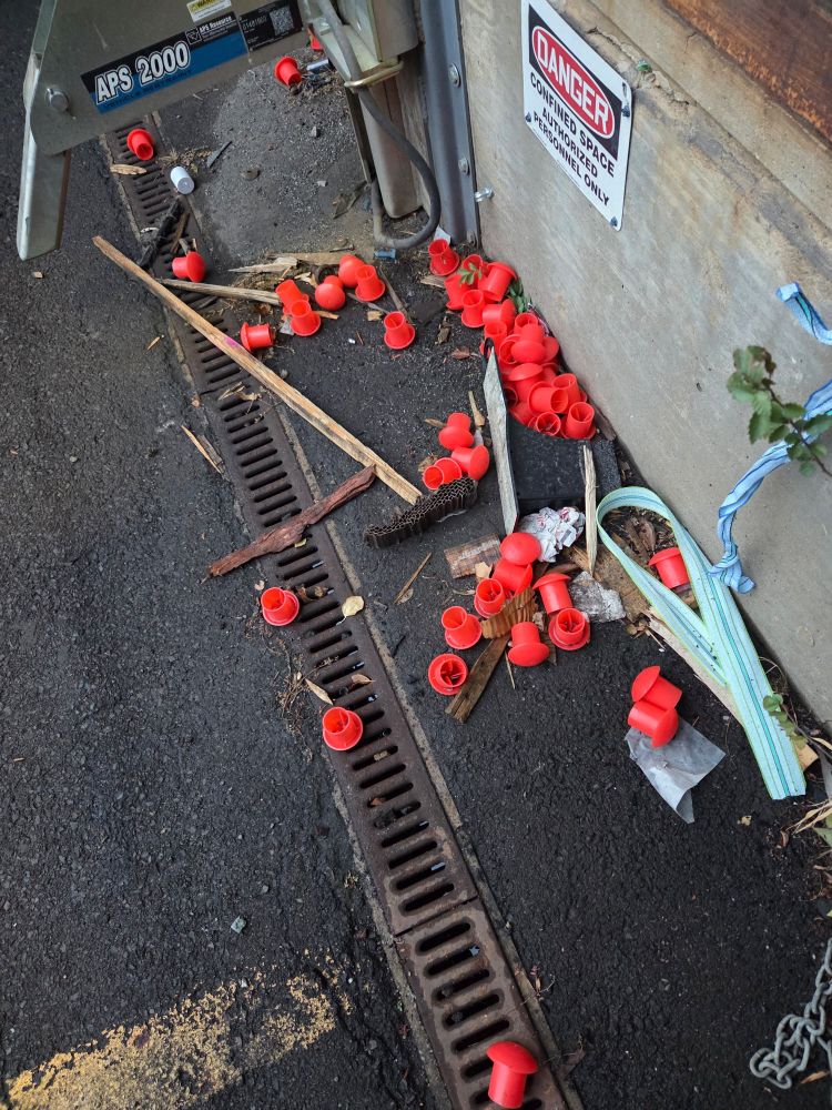 red plugs on the asphalt, what are they doing there?