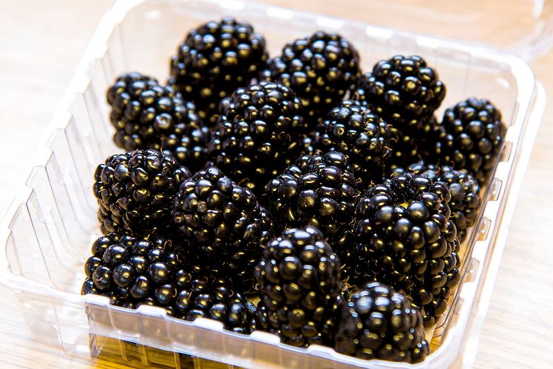 A plastic container of blackberries