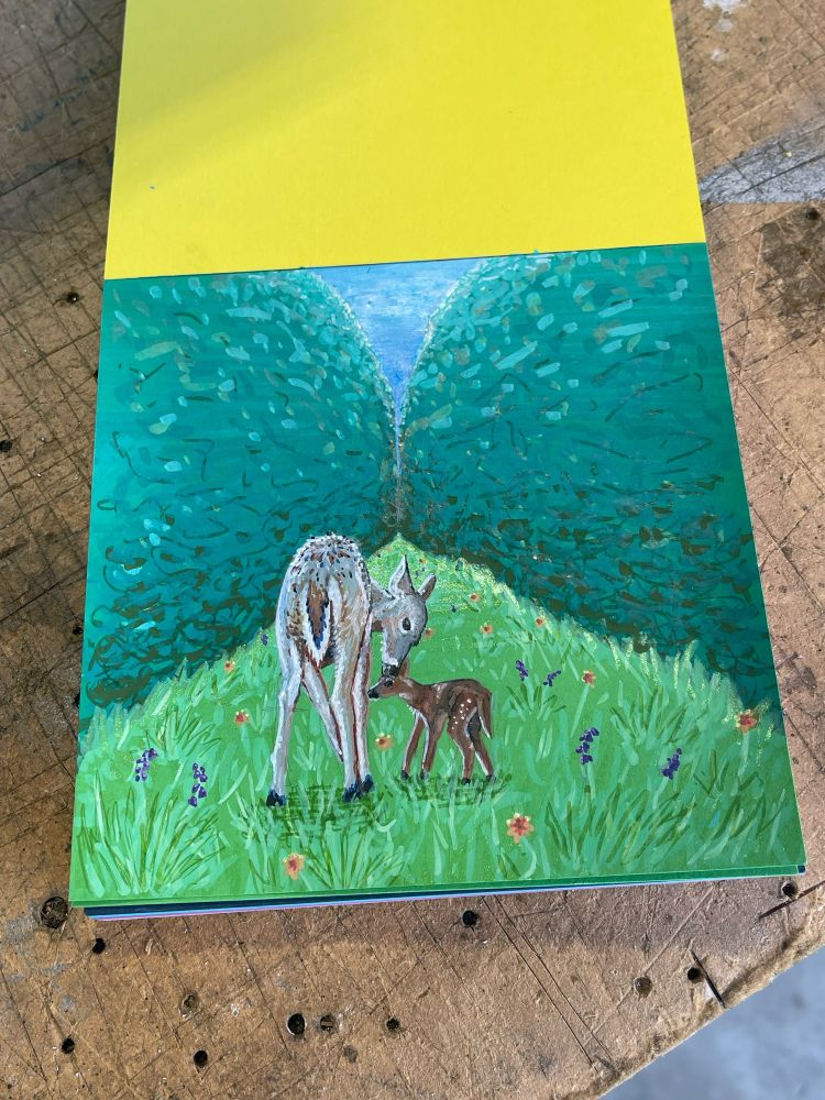 A paint marker drawing or a mother deer nuzzling a gangly fawn while both stand on a gassy path between two hedges 