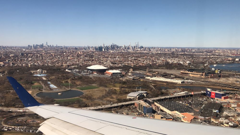 This picture shows the New York City skyline from a distance. It was taken from an airplane that was on final approach into LaGuardia Airport.