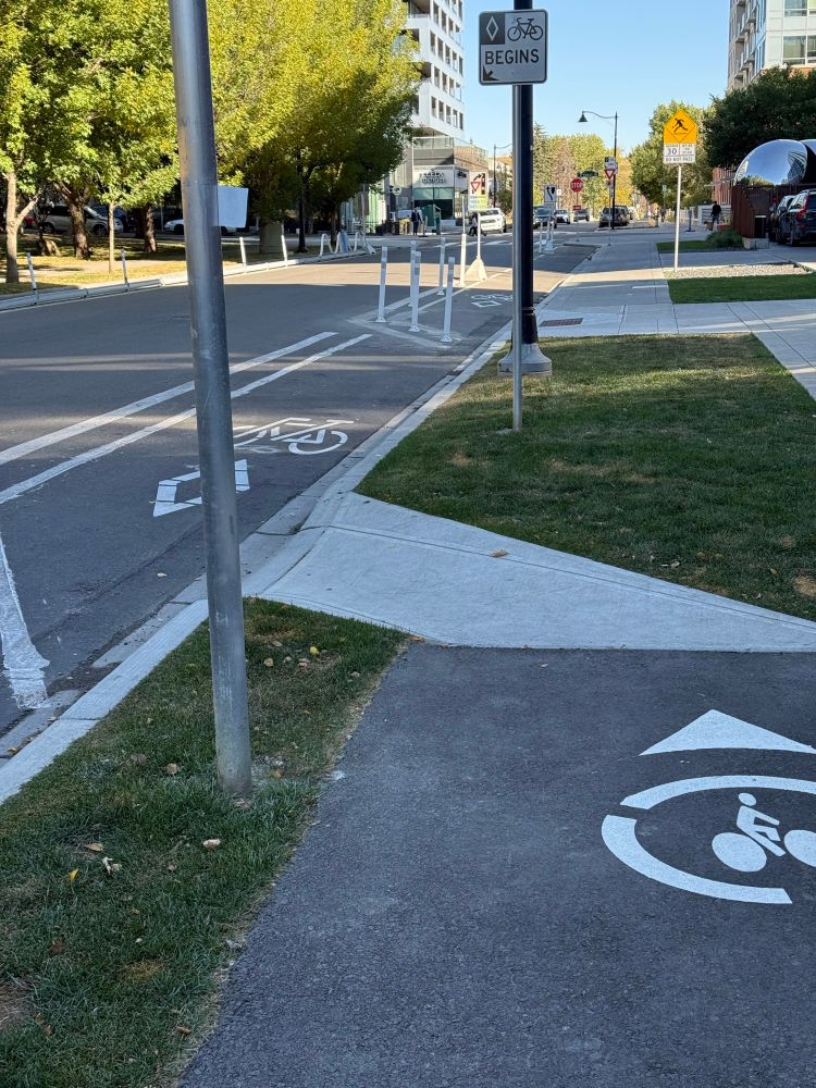On street wheeling lane with flexiposts blocking by old ramp. 