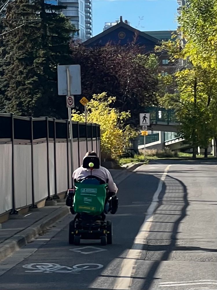 Person in mobility device using wheeling lane. 