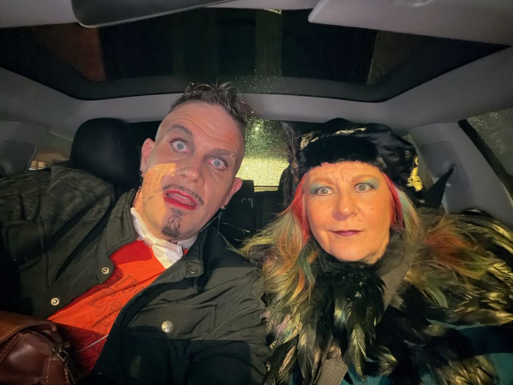 A couple of Fancy People taking a deodorant in a car.