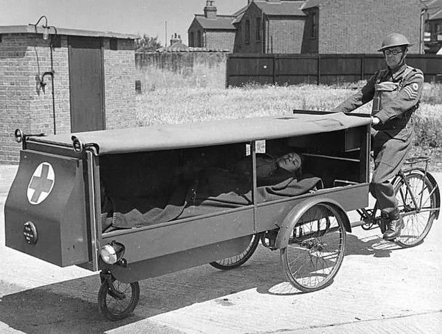 A tricycle with a thing on the front for carrying a patient.