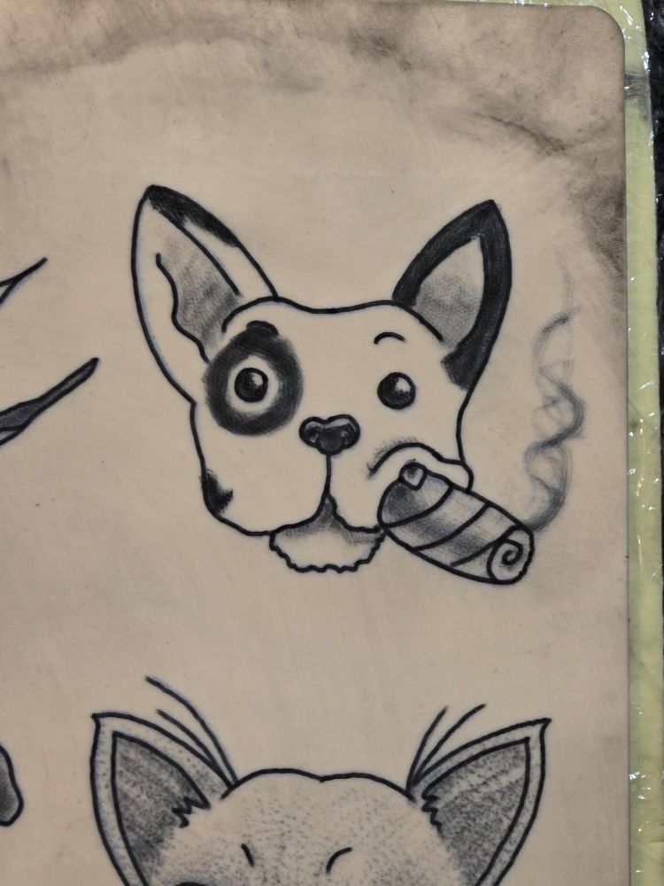 A French bulldog with a cigar, as a practice tattoo on fake skin.