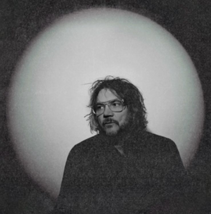 The black and white cover of Jeff Tweedy’s Twilight Overrider, featuring him in front of w white circle 