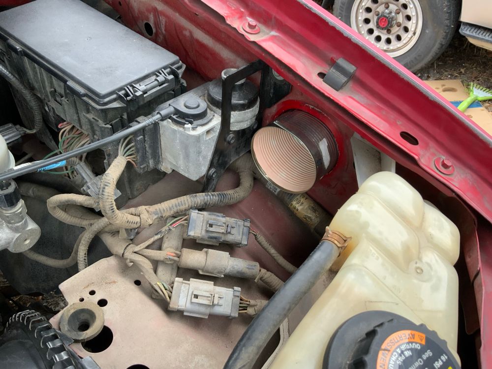 the tin can, shoved into the air inlet from the fender