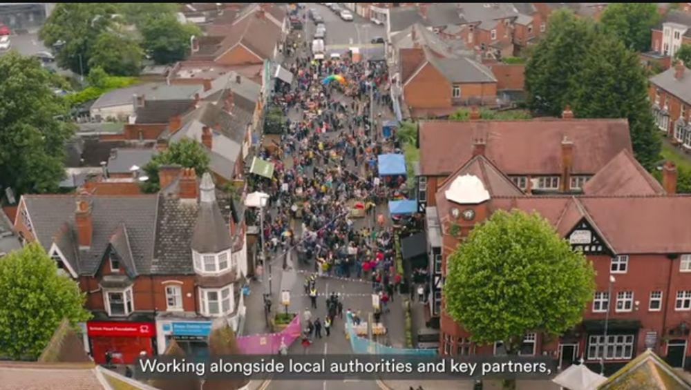 Screenshot from the WMCA film of an aerial view of a street - York Rd, Kings Heath (off a high street) full of people 