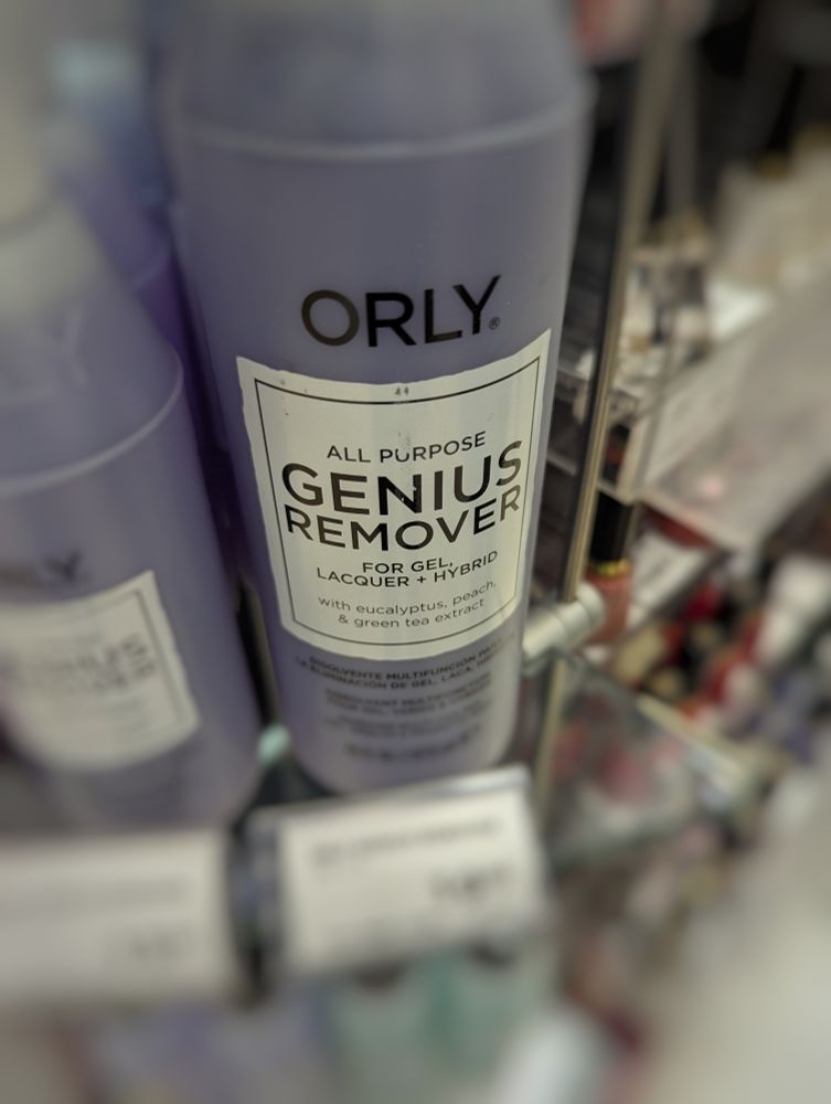 Bottle of nail polish remover that reads, "ALL PURPOSE GENIUS REMOVER".