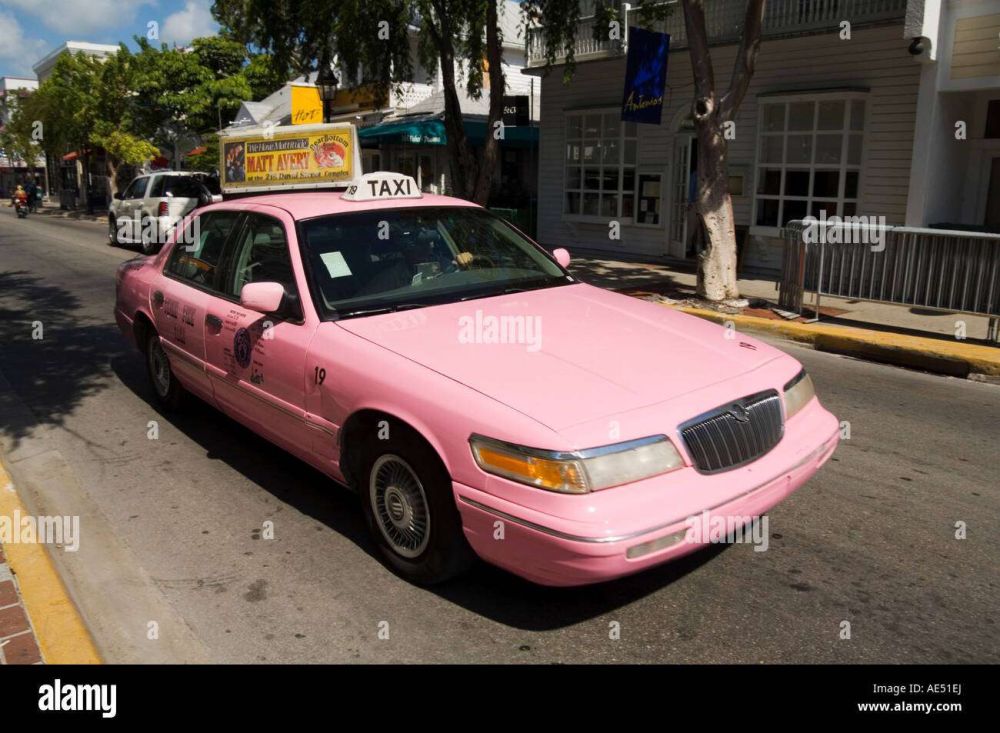 A taxi cab painted pink, possibly #CAB, the hexadecimal color for a variant of pink