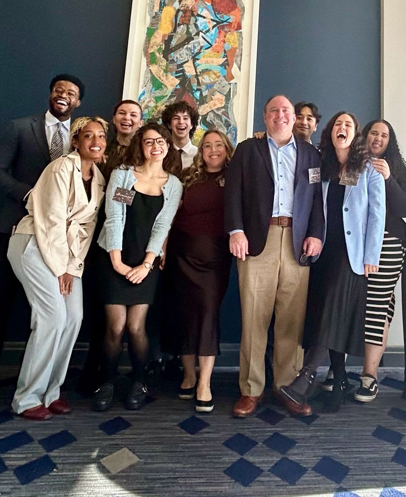 Members of the Machlus and Italiano labs pose in front of a wall. All are excited to talk science!