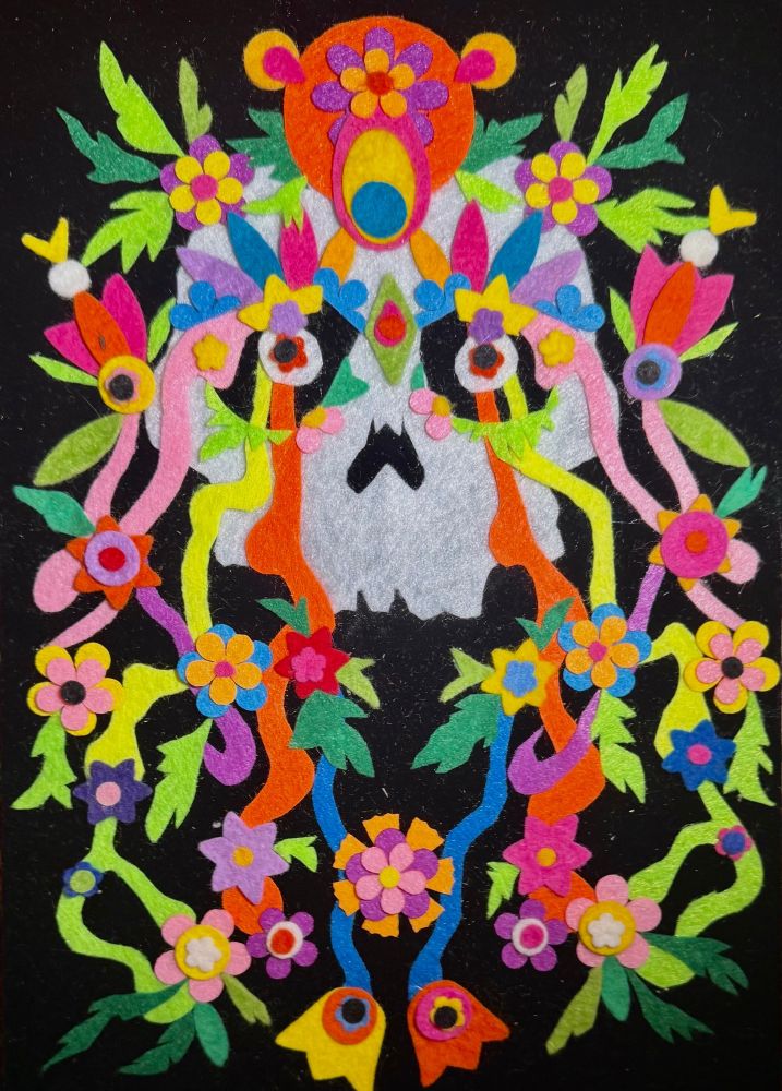 A drawing of a skull covered in colourful flowers with an orange bears head at the top.