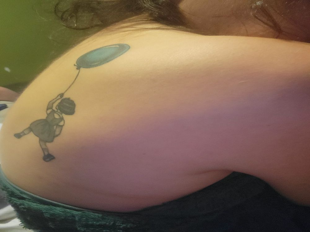 a balloon girl in black ink with a blueish green balloon