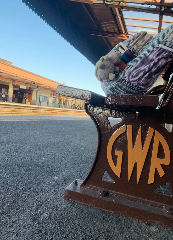 Photo of a train platform with a Great Western Railway branded bench 