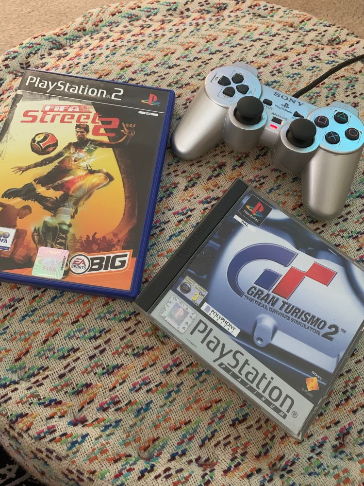 Photo of a PlayStation 2 controller, and boxes for FIFA Street 2 and Gran Turismo 2 