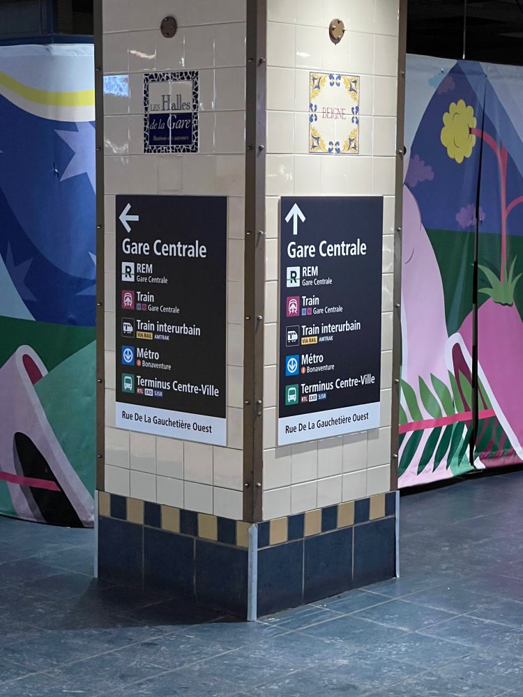 Detailed sign pointing to Gare Centrale, and trains such as the REM, exo Train, and Train Interubrain, each wth the names as services under each. Additional connections to the Métro, and Terminus Centre-Ville with bus agencies like RTL, exo and SJSR.