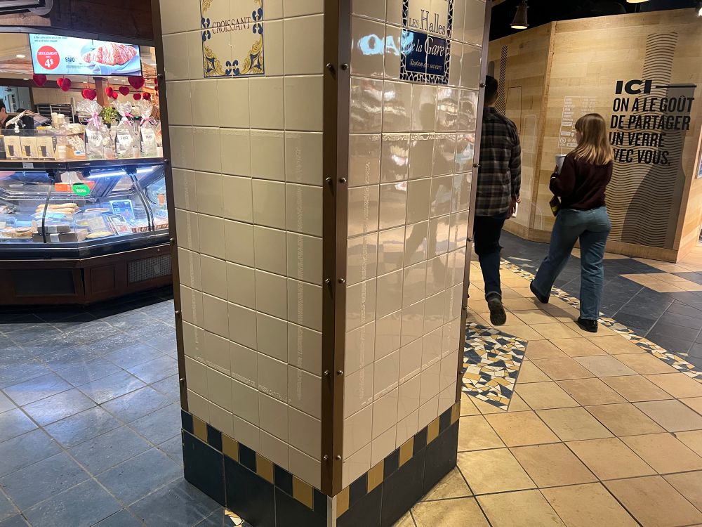 Pillar beside bakery with outline of tape residue on tile of the place of my signs