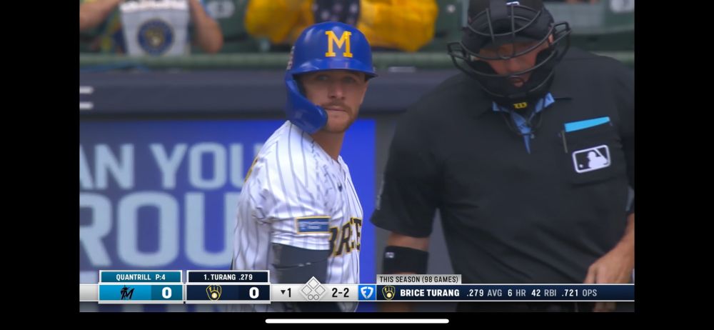 Brice Turang in batters box wearing throwback M helmet for HOF weekend.