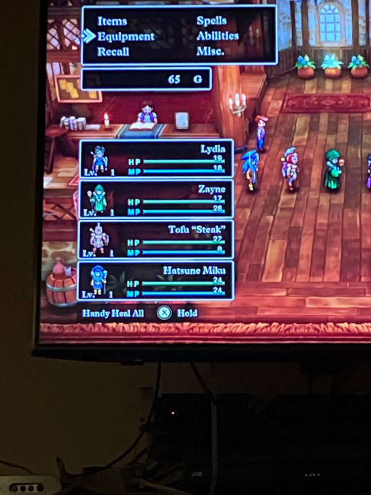 Screenshot of Dragon Quest 3 HD/2D with party members. Listed are hero Lydia, mage Zayne, Tofu “Steak” warrior, and Hatsune Miku priest. 