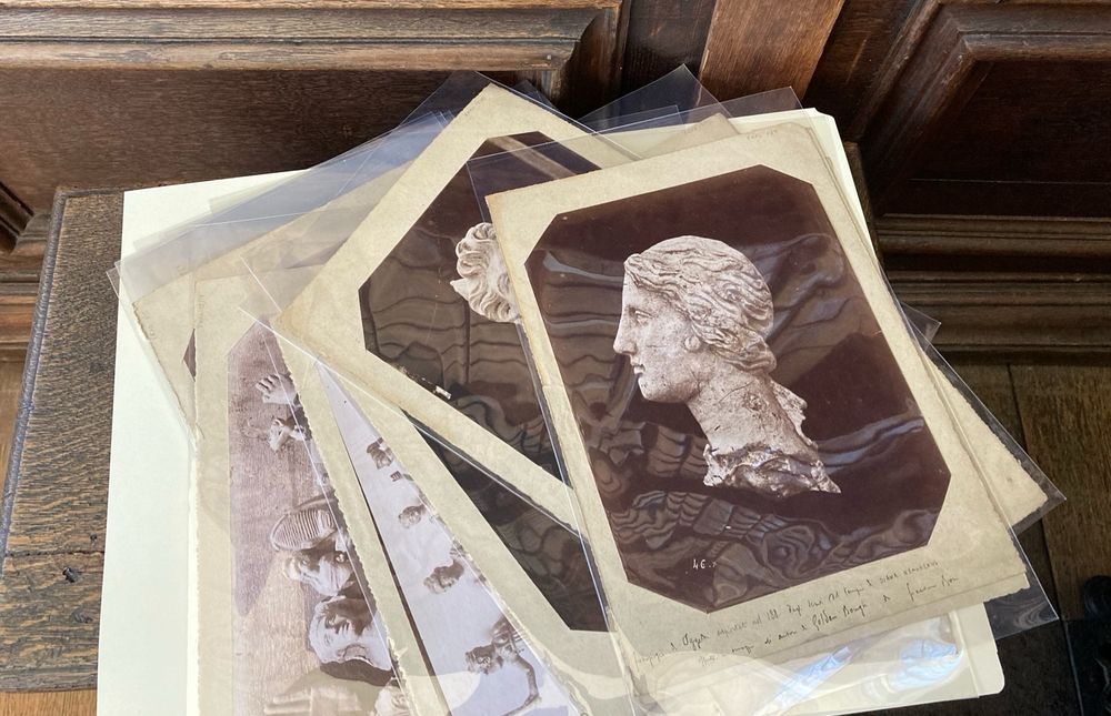 A selection of black and white photographs documenting archeological finds