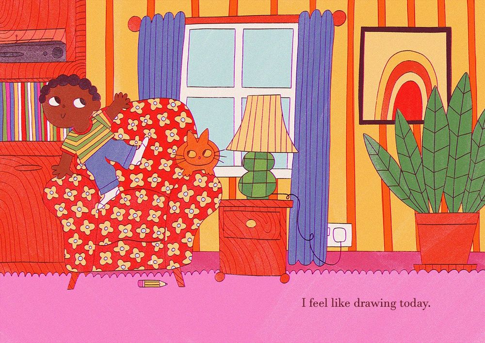 A young black boy standing on a flower patterned arm chair with an orange cat on one of the arms. They are in a colourful living room with pink carpet and yellow walls. The text says 'I feel like drawing today.'
