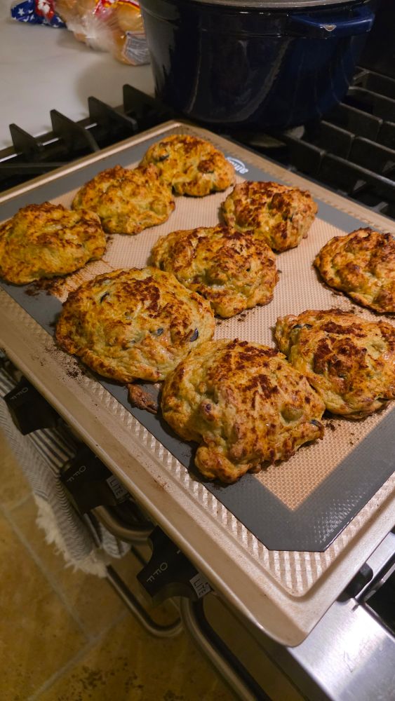 same image as prior, but baked, and set on a stove to cool rather than on the marble counter like the uncooked ones were

definitely fluffed up. much more voluminous than the previous times this user as made them. hopefully the powder and soda didnt give the "cookies" a bad flavor
