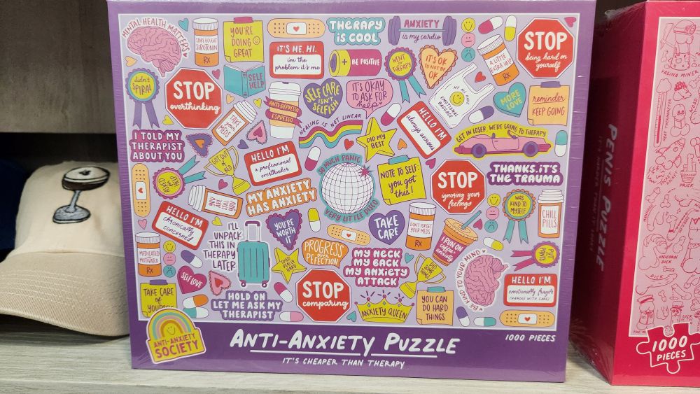 A pink box on a store shelf labeled "anti-anxiety puzzle"