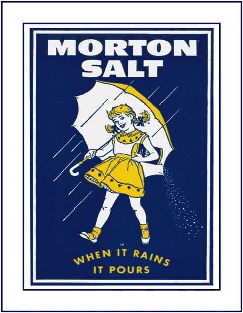 Morton salt marketing add from the 1930s. In large white letter across the top is reads “Morton Salt” under is a little girl wearing a yellow dress, with pigtails, holding a yellow umbrella with streaks of white representing rain. She is carrying an upside down canister of salt which is pouring out. At the bottom in smaller yellow print reads “When it rains it pours” 