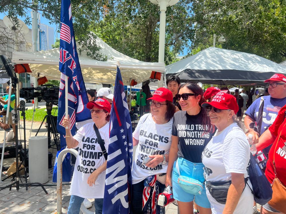 White ladies wearing “Blacks for Trump 2020” t-shirts 