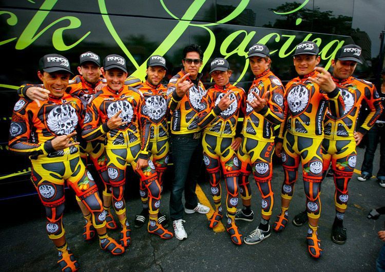 Rock racing in a cycling uniform which has an orange to yellow to red on a black background. I find it hard to describe the visual assault this outfit really was. 