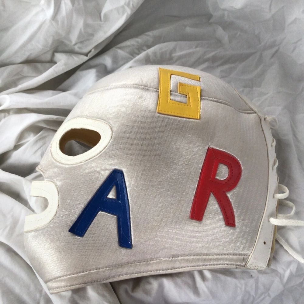 A white luchador mask with the letters "G", "A" and "R" sewn on to it for sale on Ebay.