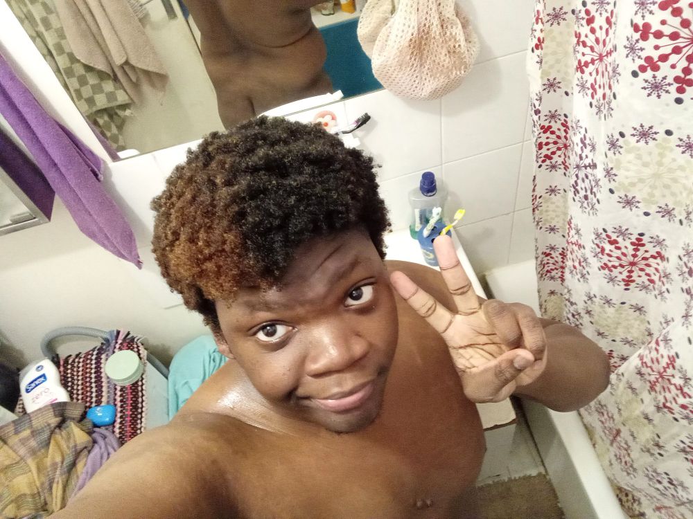 Doing a peace sign naked in my bathroom, higher angle so you can't see much down there but you can see my butt and my back thanks to a mirror