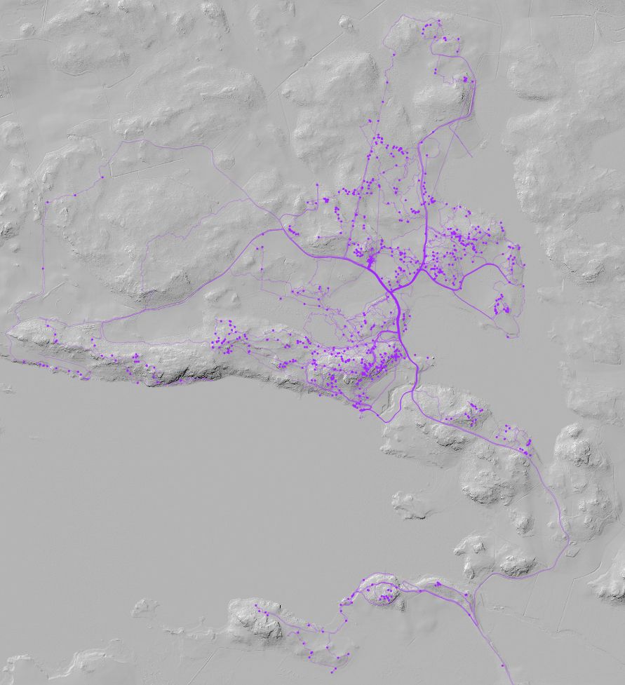 A black-and-white hillshade map with a overlay of purple points and lines.