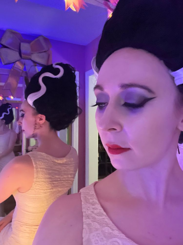 My take on the class Bride of Frankenstein look, showing off the dress and back of the wig in a mirror.