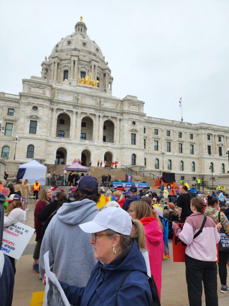 Crowds gather in front of the Saint Paul Capitol building.