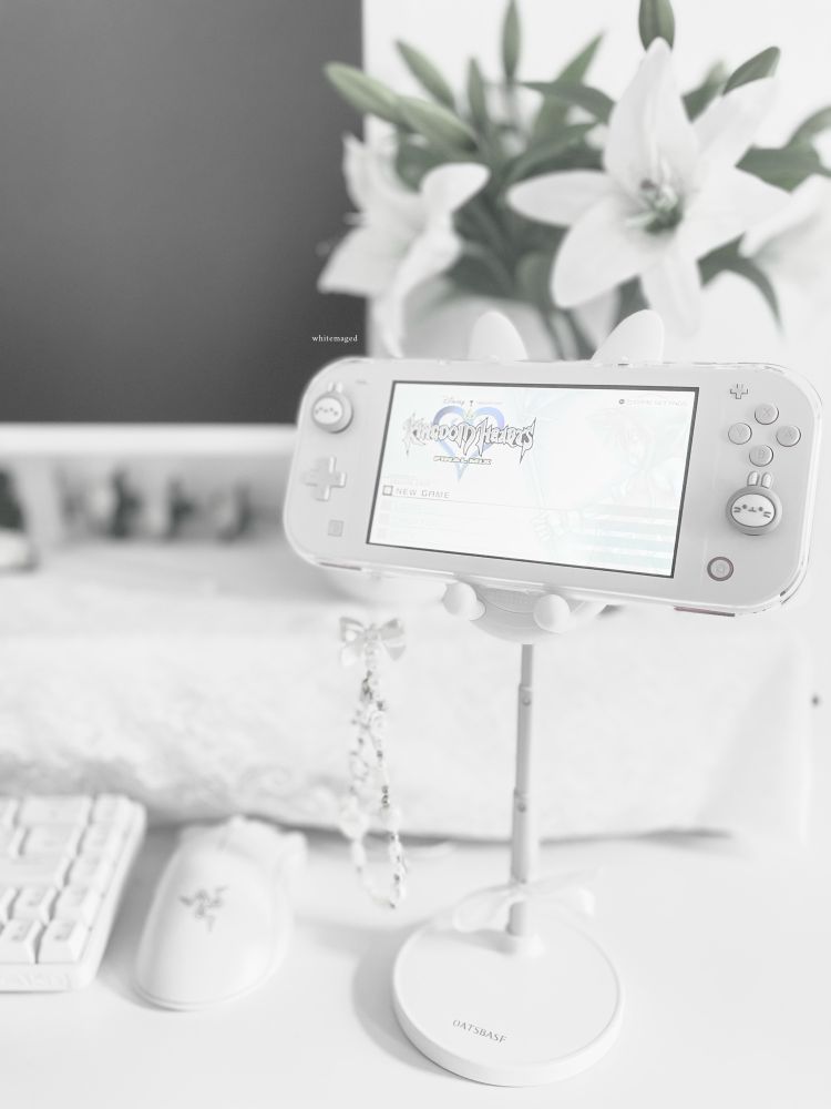 my switch lite and desk setup. kingdom hearts is displayed on the screen of the switch lite.