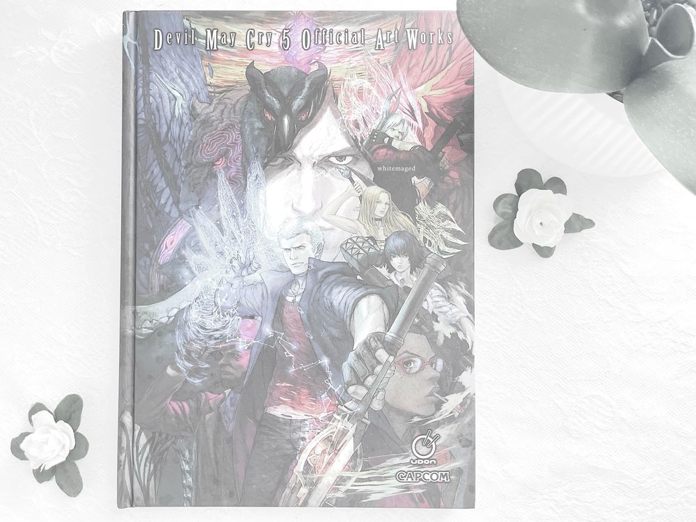the cover of the "devil may cry 5: official artworks" art book.
