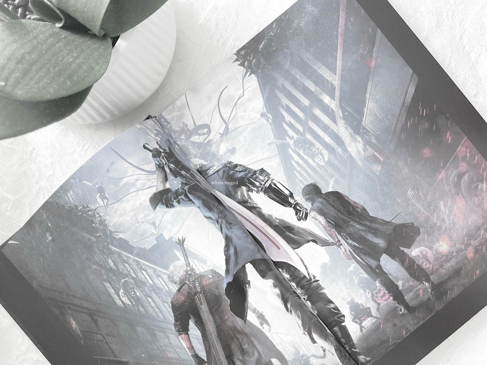 dante, nero, and v. showcased in the "devil may cry 5: official artworks" art book.