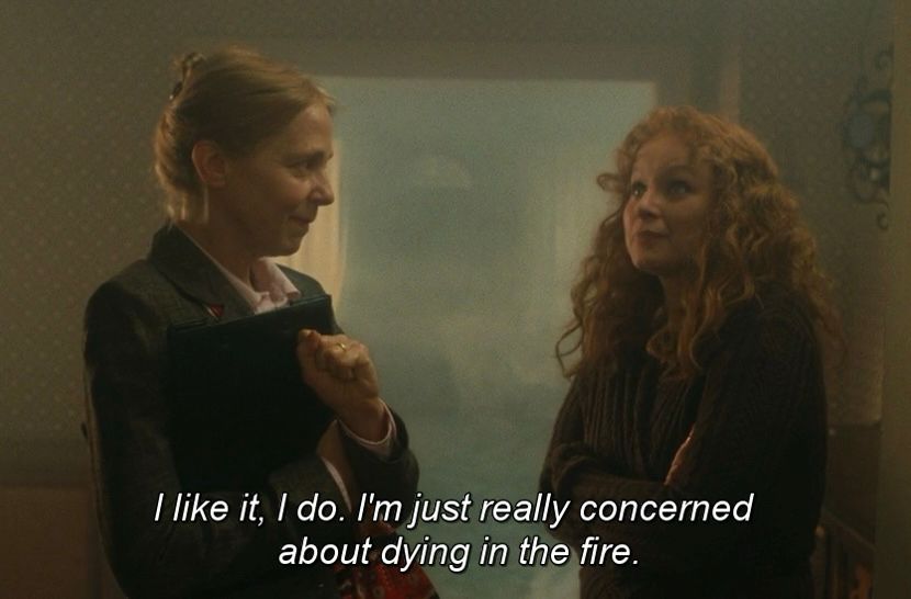 screenshot from Synecdoche, New York (2008). Hazel (Samantha Morton) tours a burning house with a realtor and says “I like it, I do. I'm just really concerned about dying in the fire.”