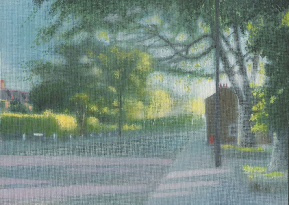 A street in West London on a summer evening. Light floods the picture casting purplish shadows across the road and highlighting the trees and bushes. The mood is tranquil and warm.