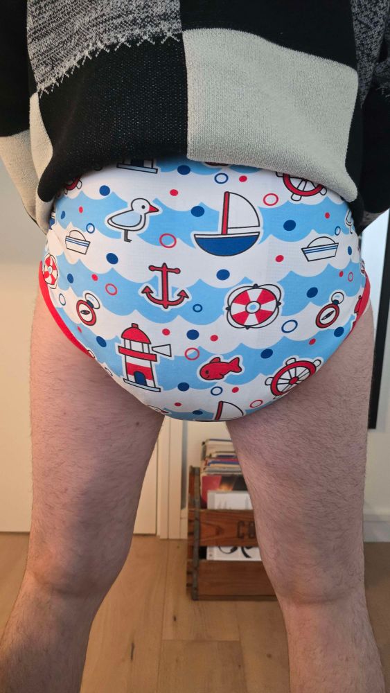 Back shot of my squishy diaper ballooning out my onesie.