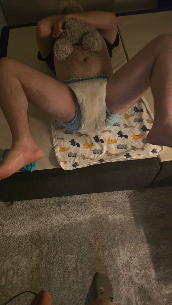 Butt! Stinky butt...seems like those knee bounces might have smooshed things out a bit...the knee bounces are stained! Oops...
Lil guy is now lying on his back on a dino print changing mat for a much needed nappy change.