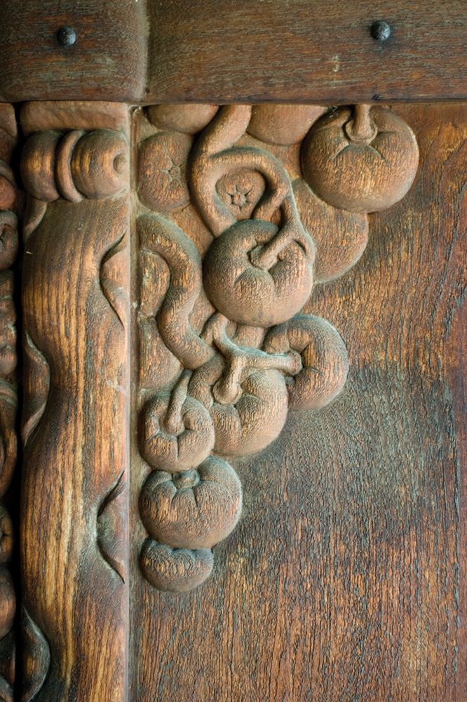 Detail of vine and fruit carving on Charles Greene studio front door.